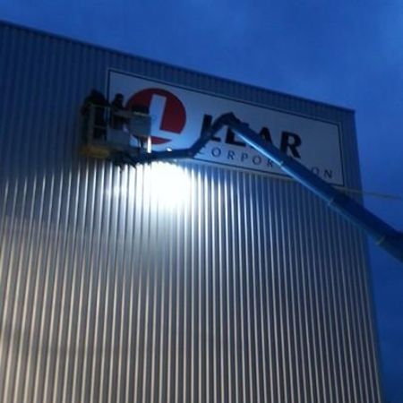 2 Mitarbeiter in einem beleuchteten Arbeitskorb im Dunkeln